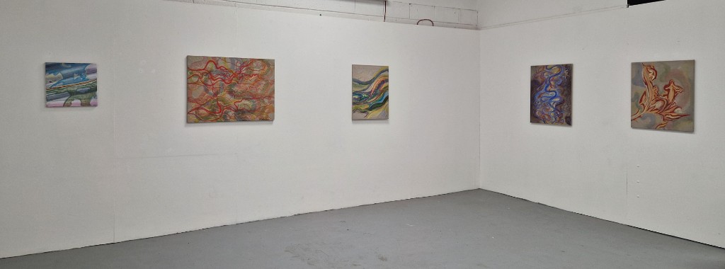 A set of paintings installed across a white gallery wall.